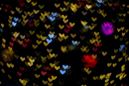 colorful abstract bokeh and blur heart shape love valentine night light on wall at shopping mall