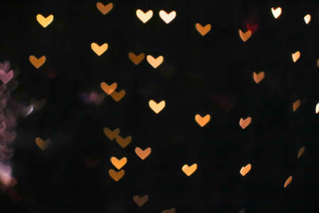 gold bokeh and blur heart shape love valentine day colorful night light on treeの写真素材