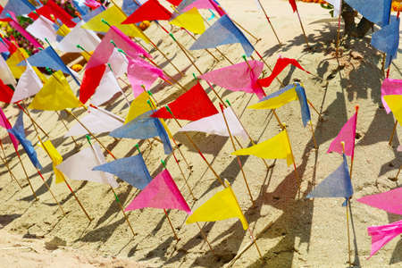 flags on sand pagoda in Songkran festival represents In order to take the sand scraps attached to...