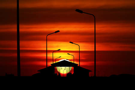 sunset colorful sky red cloud on pavilion on pier and silhouette light polesの写真素材