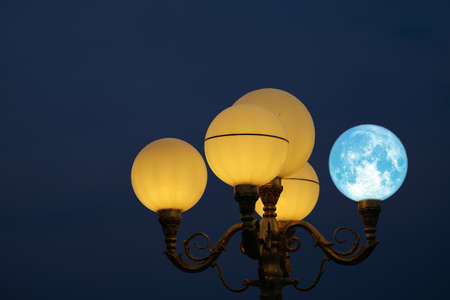 Super blue moon back on light pole in night skyの写真素材