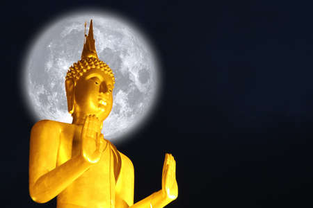 Buddha pacifying the ocean and full Buck moon on night sky in the Asanha bucha day.の写真素材