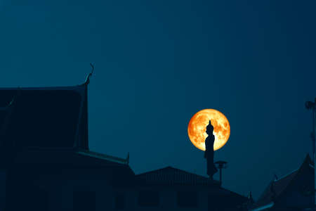 Sunday Buddha and blood moon on night sky in the Asanha bucha day.の写真素材