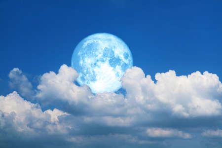 Full blue moon and white silhouette cloud sky in the night skyの写真素材