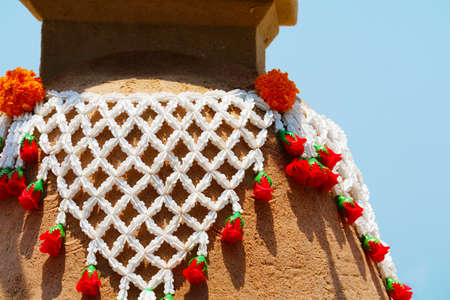 flowers on sand pagoda in Songkran festival represents In order to take the sand scraps attached to the feet from the temple to return the temple in the shape of a sand pagodaの写真素材