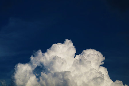 dark white heap cloud and and dark night blue sky in summer seasonの写真素材