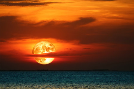 super harvest blood moon rise back blur red cloud on the night sky over the horizon seaの写真素材