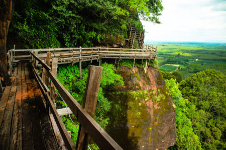 Phu Thok a beautiful wooden walkway set against a stunning natural landscape, offering a breathtaking view of a lush green valley.の写真素材