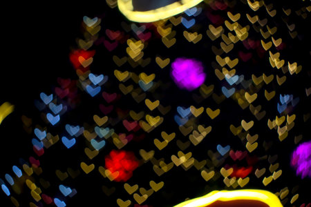purple ball abstract bokeh and blur heart shape love valentine colorful night light on wall at shopping mallの写真素材