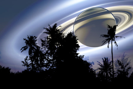 Saturn shadow under ring near earth and silhouette top coconut tree and night skyの写真素材
