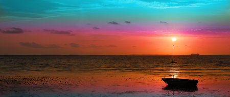 Vibrant sunset over a calm ocean with a boat silhouette, showcasing stunning gradient colors in the...