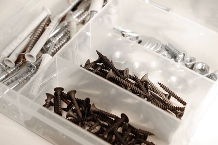 Close up of various screws inside a tool boxの写真素材