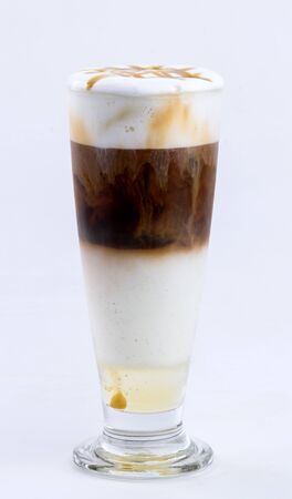 iced caramel macchiato on white backgroundの写真素材