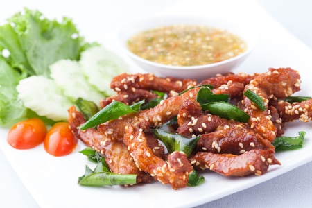 fried pork topping with white sesame on a white plateの写真素材