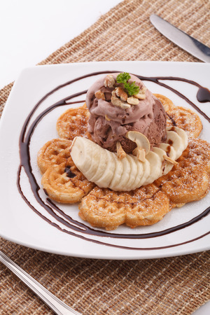Banana waffle serve with chocolate ice cream topping with cashew nutの写真素材