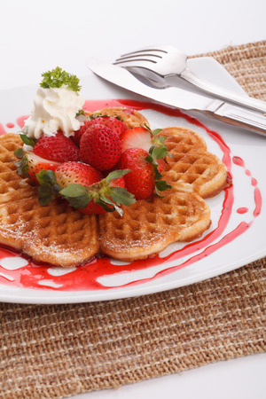 waffle topping with strawberry and decoration with strawberry sauceの写真素材