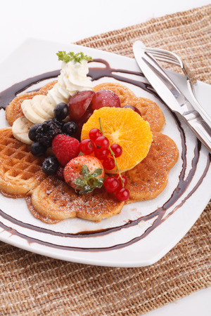 waffle with fresh fruit topping with maple syrupの写真素材