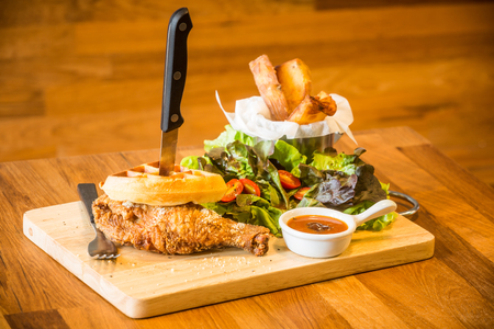 deep fried chicken wing with waffle and saladの写真素材