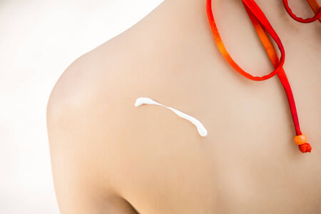 applying sunscreen lotion for protection skin from sunburnの写真素材