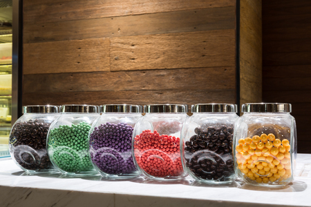 colorful candy in glass jar on the marble counterの写真素材