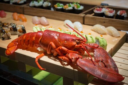 close up of big lobster on wood tray with sushiの写真素材