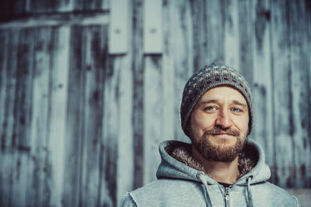 Young man with a beard and mustache outdoor portraitの写真素材