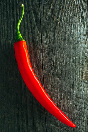 Macro photo of Organic Chili Pepper on a wooden table