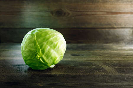 Fresh green Cabbage on rustic wooden background