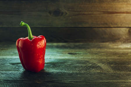 Fresh ripe bell pepper on a wooden table