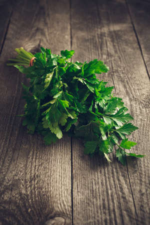Fresh Green bunch of parsley on the wood background, natural lightの写真素材