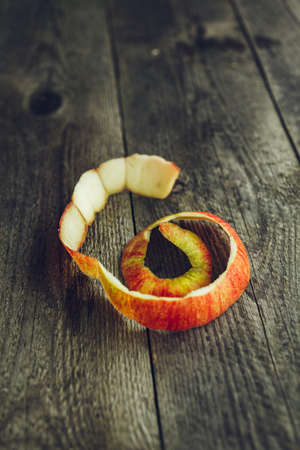 Bright Peel of an organic apple on wooden backgroundの写真素材