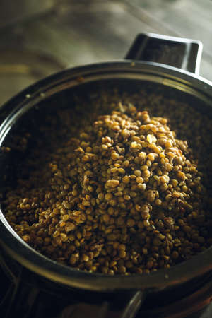 Steamed brown lentils in a pot, soft focusの写真素材