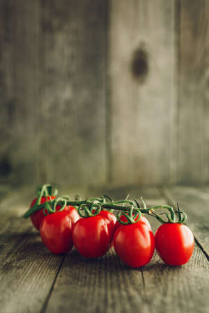 Red Organic Cherry tomatoes on wooden backgroundの写真素材