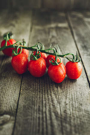 Red Organic Cherry tomatoes on wooden backgroundの写真素材