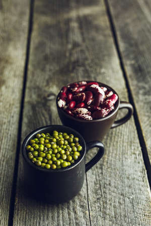 Green Mung Beans and Red Speckled Kidney Beans on a wooden backgroundの写真素材