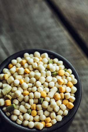 Macro shot of Colorful Couscous in a small cup on a wooden backgroundの写真素材