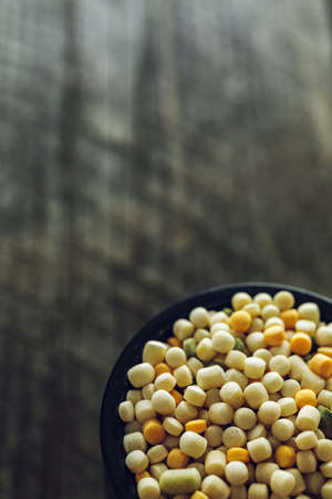 Macro shot of Colorful Couscous in a small cup on a wooden backgroundの写真素材