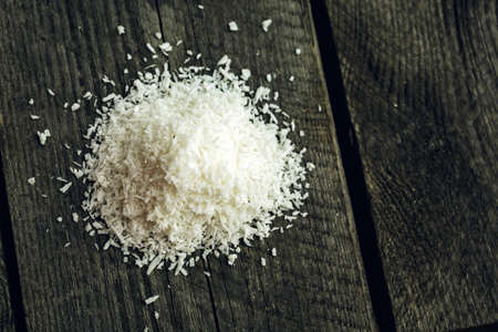 Pile of Dessicated Coconut flakes on a wooden backgroundの写真素材