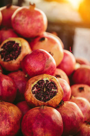 Red pomegranates at Farmers' marketの写真素材