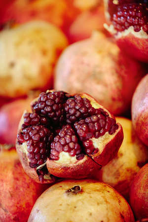 Red pomegranates at Farmers' marketの写真素材