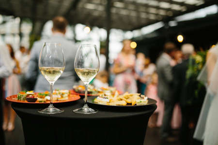 Catering service. Wedding table with wine glasses and snacks. Wedding reception.の写真素材