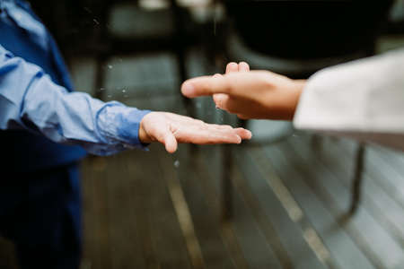 Kids catching raindrops at wedding reception. Soft focus.