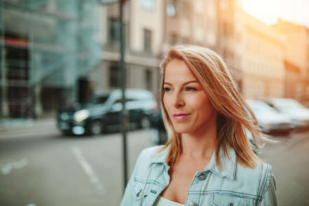 City portrait of a beautiful young woman. Soft focus, fine film gain texture.