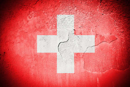 Swiss flag painted on grungy cracked wallの写真素材