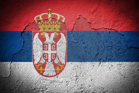 Serbia flag painted on grungy cracked wallの写真素材