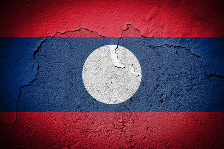 Laos flag painted on grungy cracked wallの写真素材