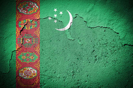 Turkmenistan flag painted on grungy cracked wallの写真素材