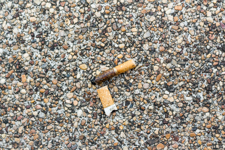 A burnt used cigarette left on the floor.の写真素材