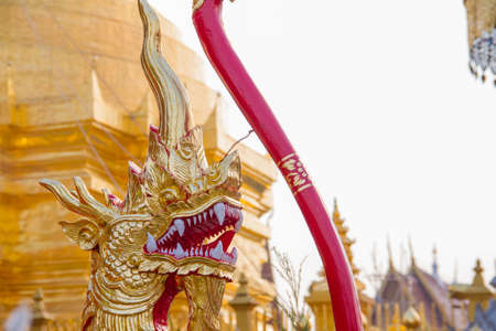 golden na-ga statue with Jedi at lamphun Thailandの写真素材