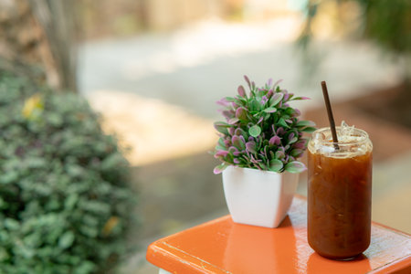 iced black coffee in a beautiful glass on a wooden tableの写真素材